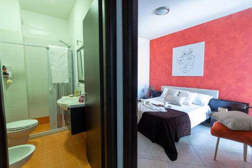 a hotel room with a bed and a bathroom at Residence Borgo & Mare - Localo in Melendugno