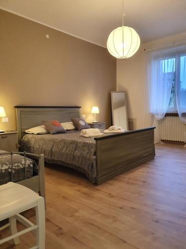 a bedroom with a large bed and a lamp at Villa Lida Apartment, in collina con ampio terrazzo e vista mare in Giulianova