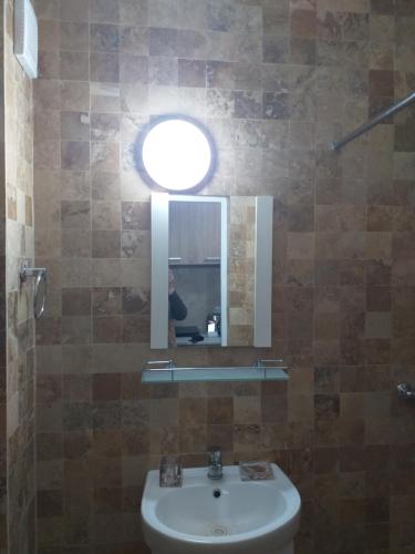 a bathroom with a sink and a mirror at Studio Saturn in Saturn