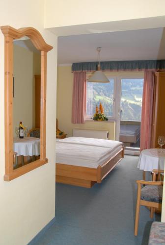 a bedroom with a bed and a large window at Laterndl-Wirt in Sankt Veit im Pongau