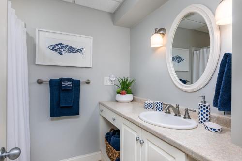 a bathroom with a sink and a mirror at Beautiful PRIVATE Oasis - On the River's Edge in Kennebunk