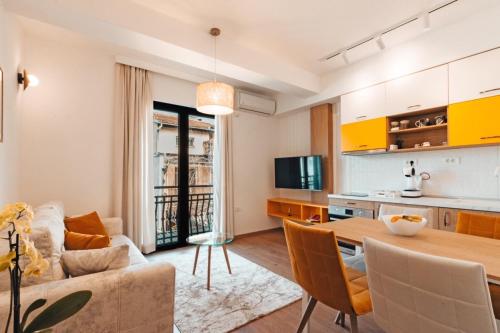 a kitchen and living room with a table and a couch at Blue Lake Apartments in Ohrid