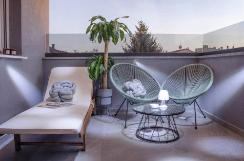 a balcony with two chairs and a table and a plant at Villa Kap in Zagreb