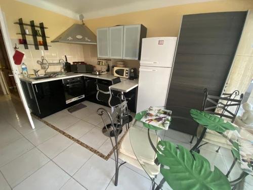 a kitchen with a white refrigerator and a table at appartement à Cannes in Cannes