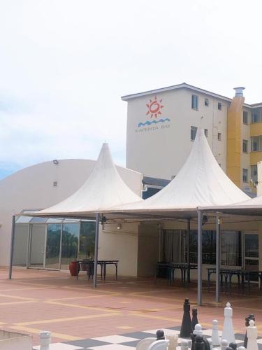 a group of white tents in front of a building at Kapenta Bay Holiday Resort Port Shepstone unit 12 in Port Shepstone