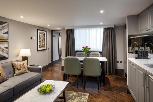 a living room with a couch and a table at Hapimag Apartments London in London