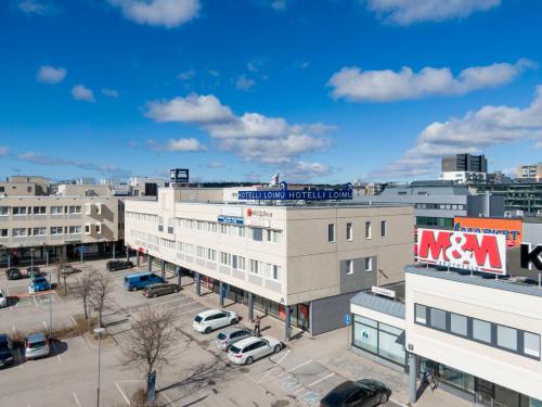 an aerial view of a parking lot in a city at Hotelli Loimu by UHANDA in Raisio