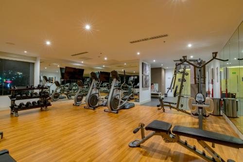 a gym with a lot of treadmills and exercise equipment at Torre Lucerna Hotel Ensenada in Ensenada