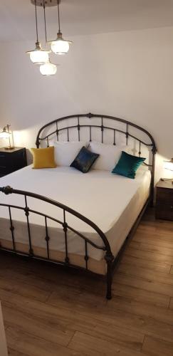 a bedroom with a large bed with pillows on it at SAVAS CLASIC BRASOV in Braşov