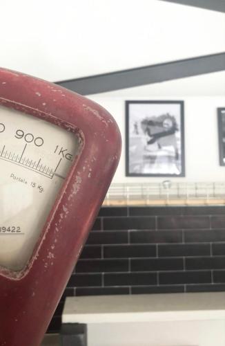 a close up of a clock next to a wall at 87029house in Scalea