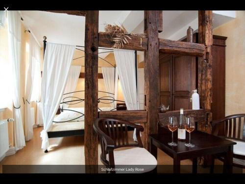a bedroom with two bunk beds and a table with wine glasses at Altstadtmeise Rustika in Meisenheim