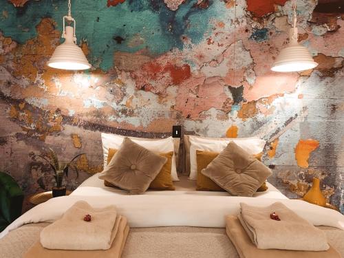 a bedroom with a white bed with two pillows at Lush in Graskop