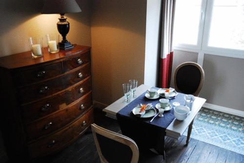 uma sala de jantar com mesa e cadeiras e uma cómoda em B&B Villa des Roses em Hasselt