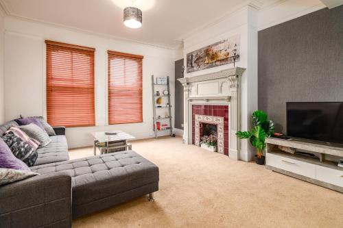 a living room with a couch and a fireplace at Spacious Contractor House for Large Groups - Private Parking in Northampton