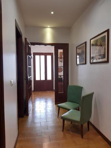 a hallway with a green chair and a door at Casa Vacanze Riviera del Brenta in Dolo