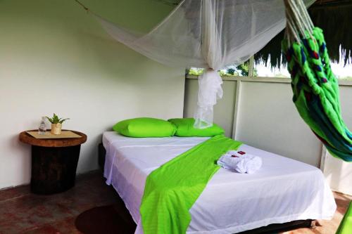a bedroom with a bed with a canopy over it at Mirador del Parque Tayrona in El Zaino