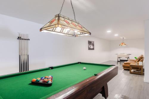 a living room with a pool table in a room at Chill House in Santa Barbara