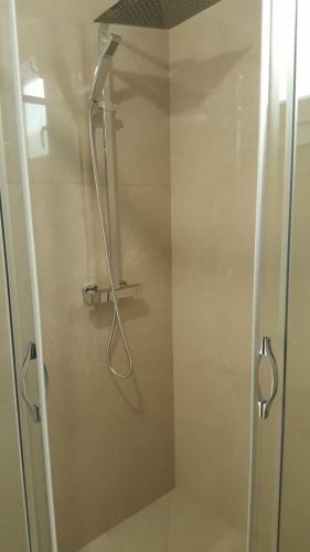 a shower with a glass door in a bathroom at Elite Luxury Residence in Torre Suda