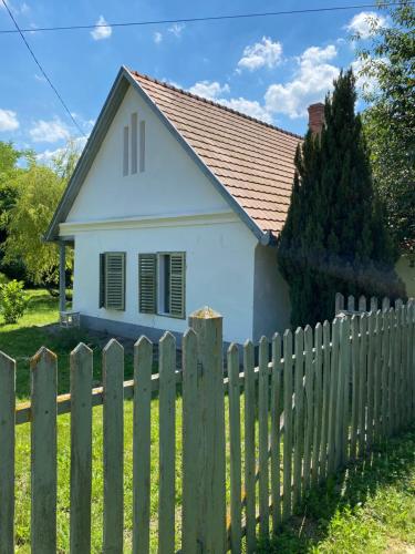 a white house behind a fence at Hidden gem in the hills of Somogy County in Somogydöröcske