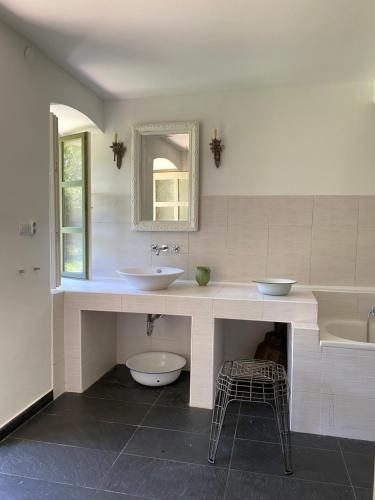 a bathroom with two sinks and a tub and a mirror at Hidden gem in the hills of Somogy County in Somogydöröcske