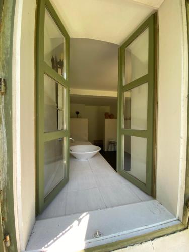 a bathroom with two large windows and a bath tub at Hidden gem in the hills of Somogy County in Somogydöröcske