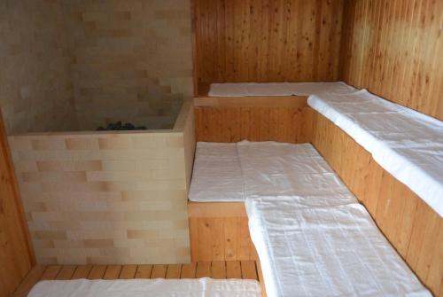 a room with two beds in a sauna at Shiretoko Noble Hotel in Shari