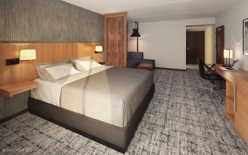 a hotel room with a bed and a desk at Hyatt Place Boston/Braintree in Braintree