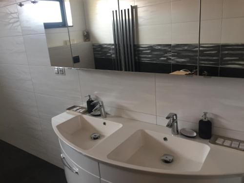 a bathroom with a white sink and a mirror at Penzion Za radnicí in Valtice
