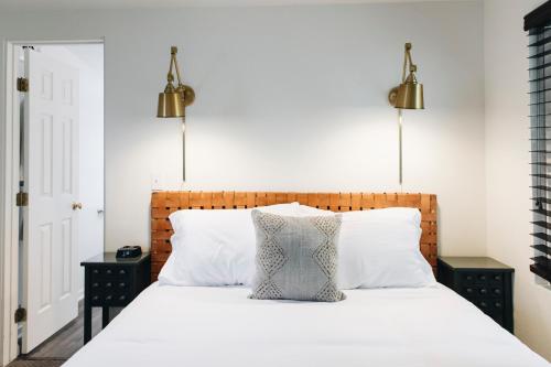 ein Schlafzimmer mit einem weißen Bett und zwei Nachttischen in der Unterkunft Sonoma's Best Guest Cottages in Sonoma