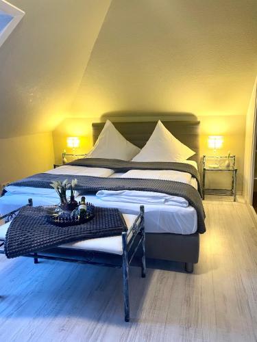 a large bedroom with two beds and a table at Orchidee in Niebüll