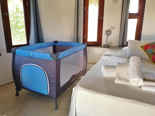 a bedroom with a bed with a blue cabinet on it at Casa Cacahuate Holbox-Casa entera con jardin-Whole house with garden in Holbox Island
