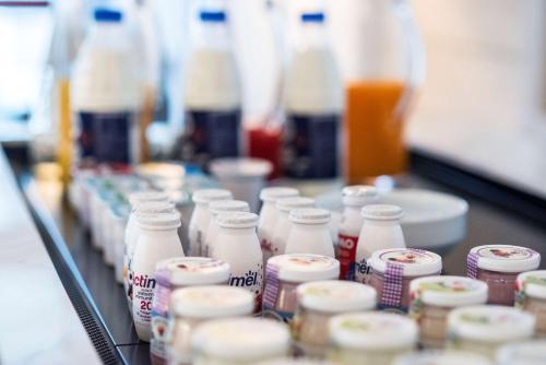 a row of bottles of milk on a counter at Best Western Hotel Quattrotorri in Perugia