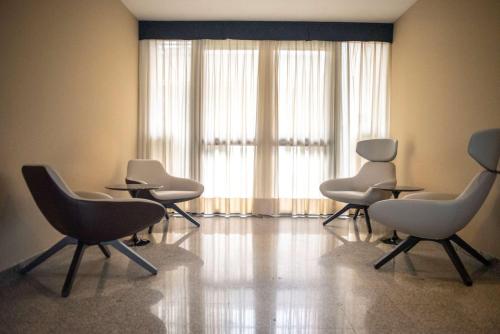 a waiting room with chairs and a large window at Best Western Hotel Quattrotorri in Perugia