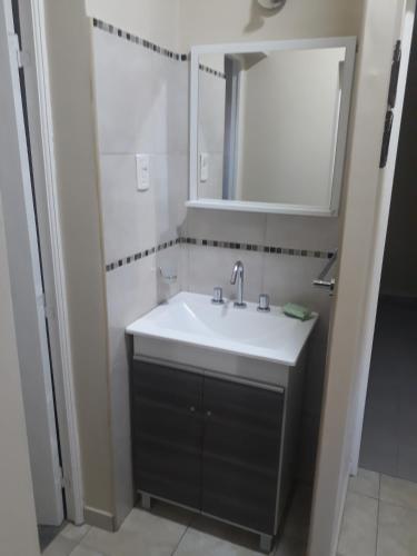 a bathroom with a sink and a mirror at Casa de campo Las olivas in San Rafael