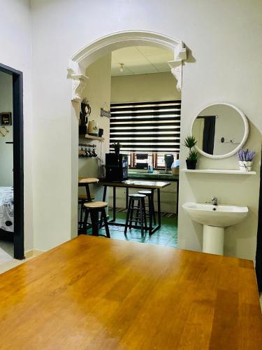 a living room with a table and a sink at Homestay Wan D in Kota Bharu