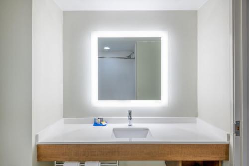 a bathroom with a white sink and a mirror at Holiday Inn Express & Suites St George North - Zion by IHG in Washington
