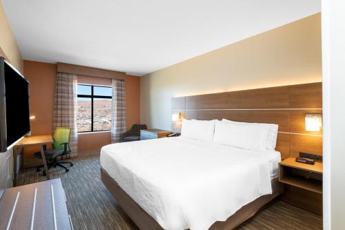 a hotel room with a bed and a television at Holiday Inn Express & Suites St George North - Zion by IHG in Washington