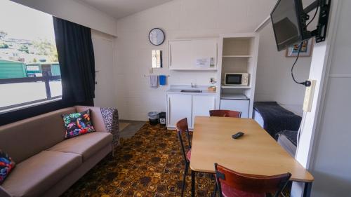 a living room with a couch and a table at Whangarei Central Holiday Park in Whangarei