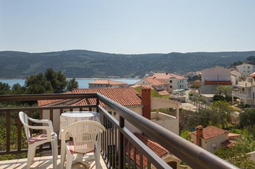 a balcony with two chairs and a table and a view at Apartments S&M in Marina