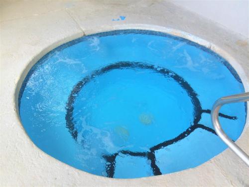 a pool of blue water with a net in it at High Sierra Condominiums in Ruidoso