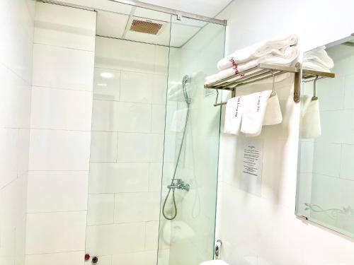 a bathroom with a shower with a glass door at Khách sạn Long Hà in Can Tho
