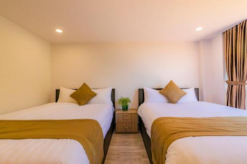 Giường trong phòng chung tại Khanh Uyen 3 Hotel & Apartment