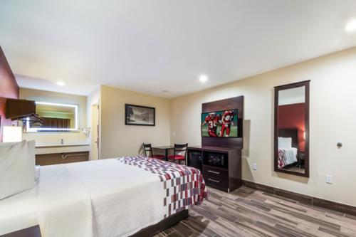 a hotel room with a large bed and a mirror at Ocean's Edge Hotel, Port Aransas,TX in Port Aransas