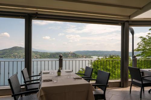 a table on a balcony with a view of the water at Hotel Ristorante San Carlo in Arona