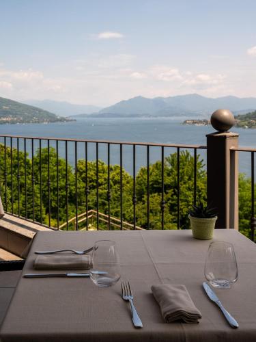 a table with two wine glasses and a view of the water at Hotel Ristorante San Carlo in Arona