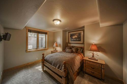 a bedroom with a bed and a window at Bear Discovery Custom Tamarack Estate Home by Casago McCall - Donerightmanagement in Donnelly