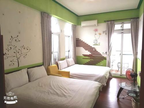 a bedroom with two beds and a staircase in it at 花沐嵐民宿 in Taitung City