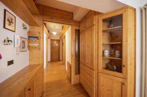 a hallway in a log cabin with wooden cabinets at Ciasa Goti in Moena