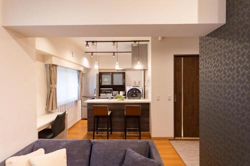 a living room with a couch and a kitchen at NIYS apartments 03 type in Tokyo