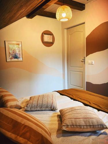 a bedroom with a bed with pillows on it at Cabana Khaliope in Floroaia Mică